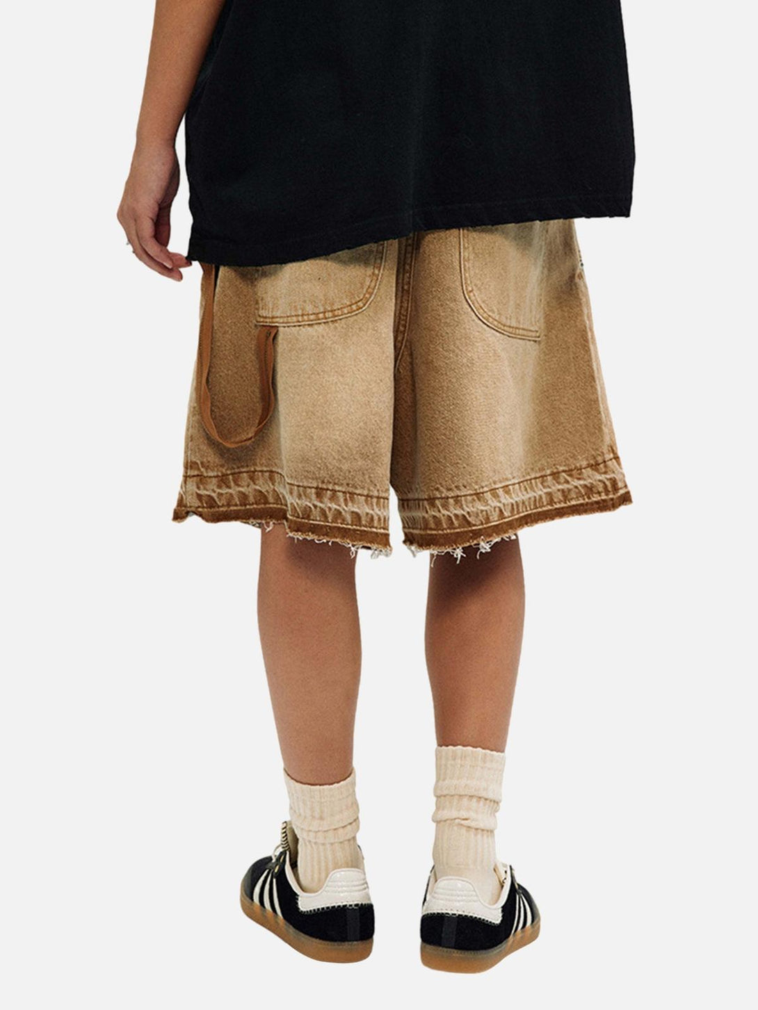 Back view of TALISHKO's retro denim shorts, featuring a distressed finish with casual sneakers.