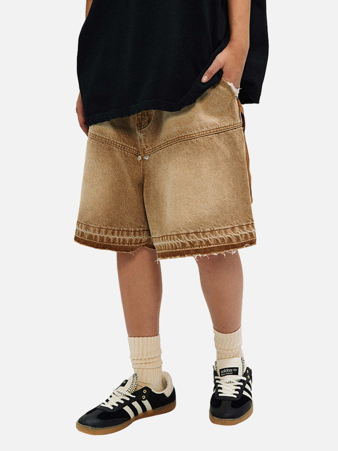 TALISHKO denim shorts with a retro, distressed finish, worn casually with sneakers.