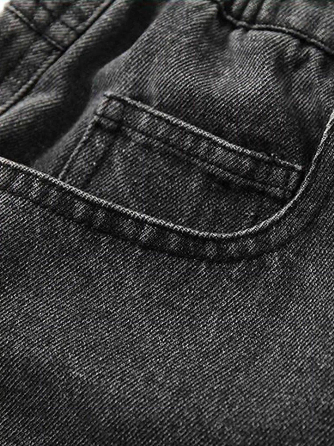 Detailed fabric and stitching on TALISHKO jeans, highlighting the retro embroidery style.