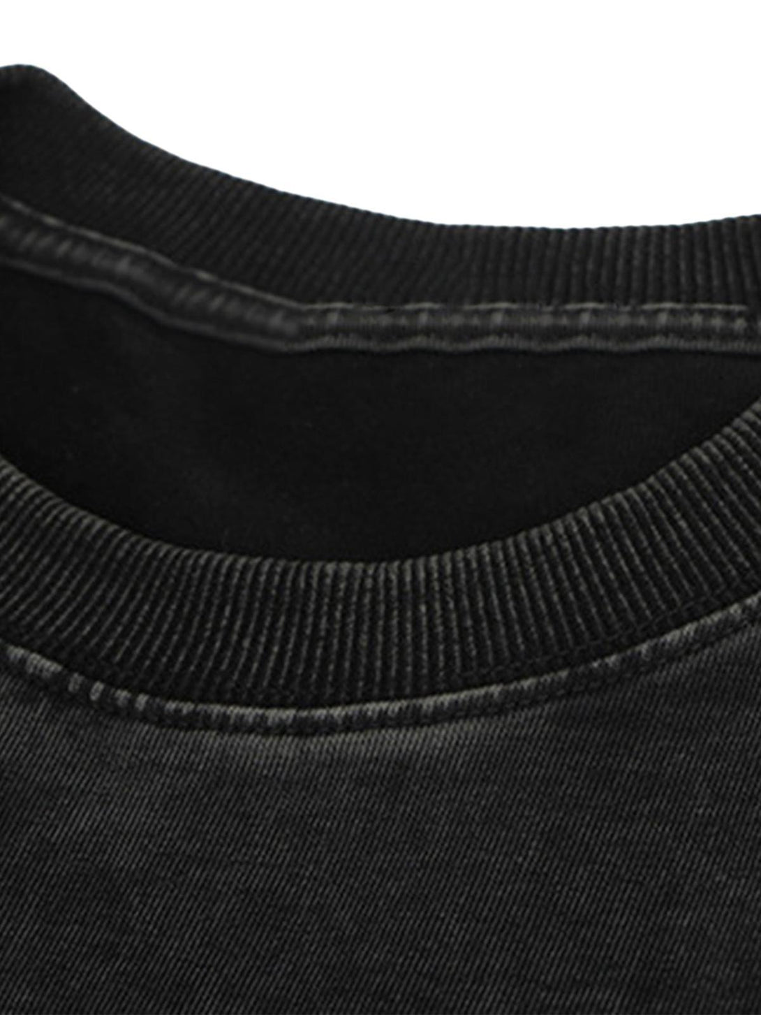 Detailed look at the neckline stitching of a black TALISHKO street-style T-shirt.