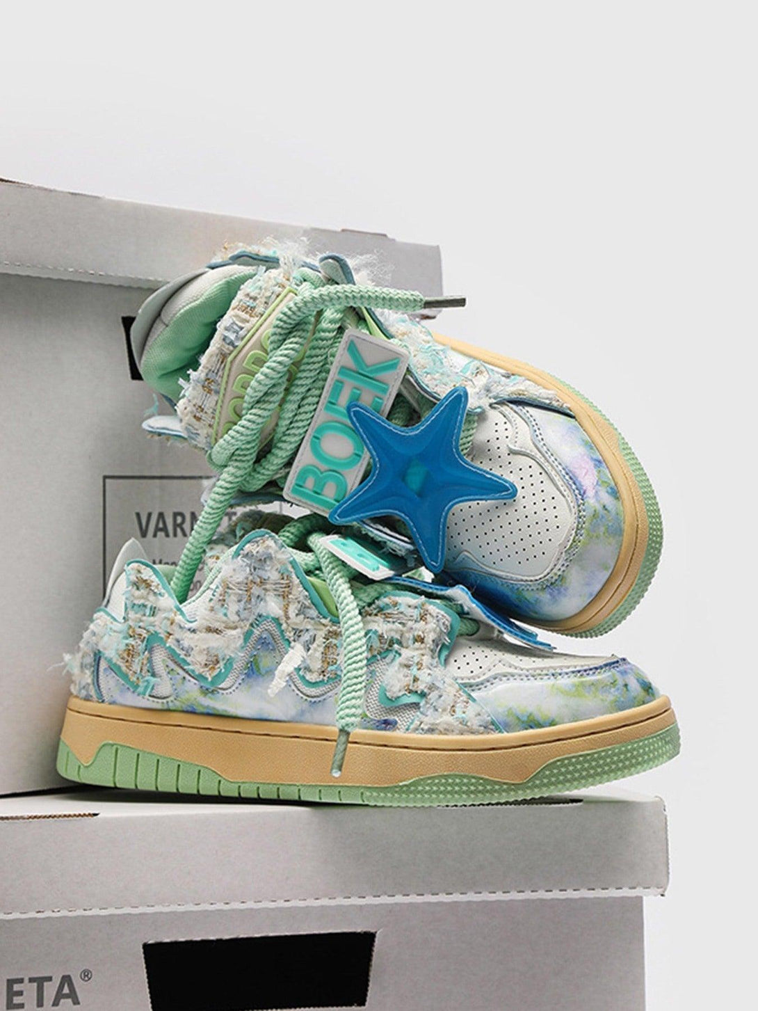 TALISHKO sneakers with blue star accents and textured pastel details, adding retro flair.