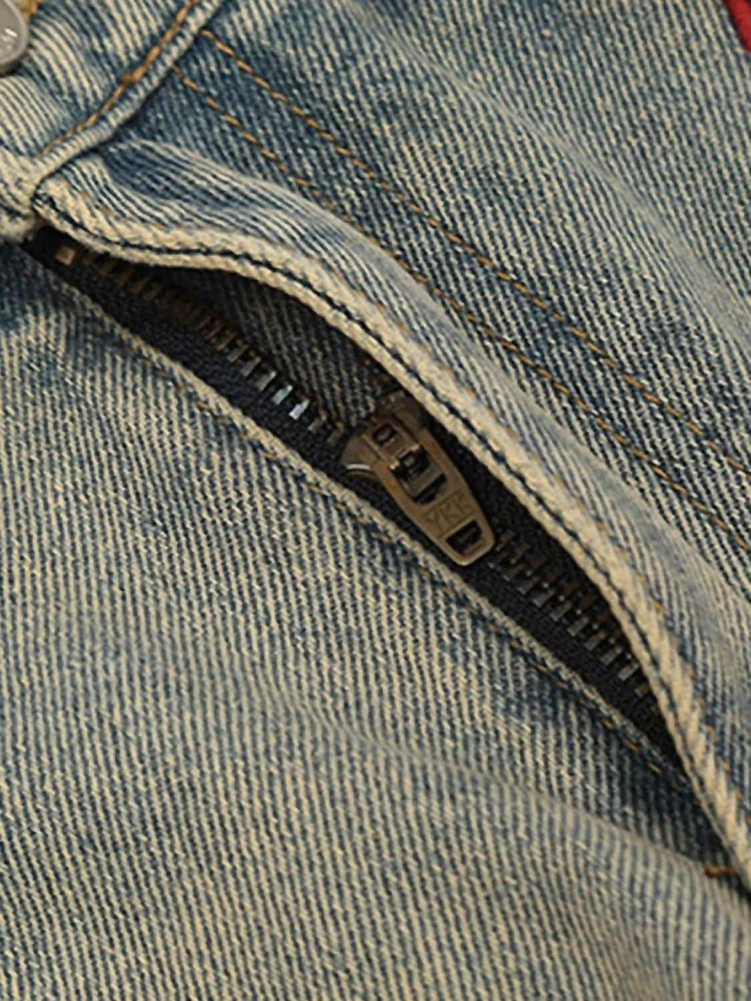 A detailed look at TALISHKO jeans' zipper and stitching, highlighting their retro hip-hop style.