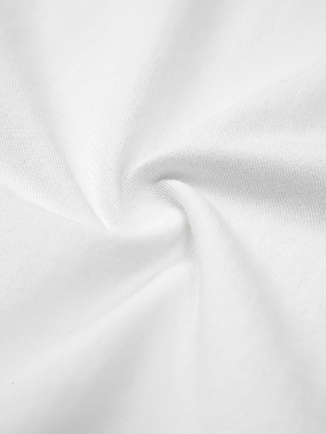 Intricate look at TALISHKO's white shirt fabric, highlighting its smooth texture and quality.