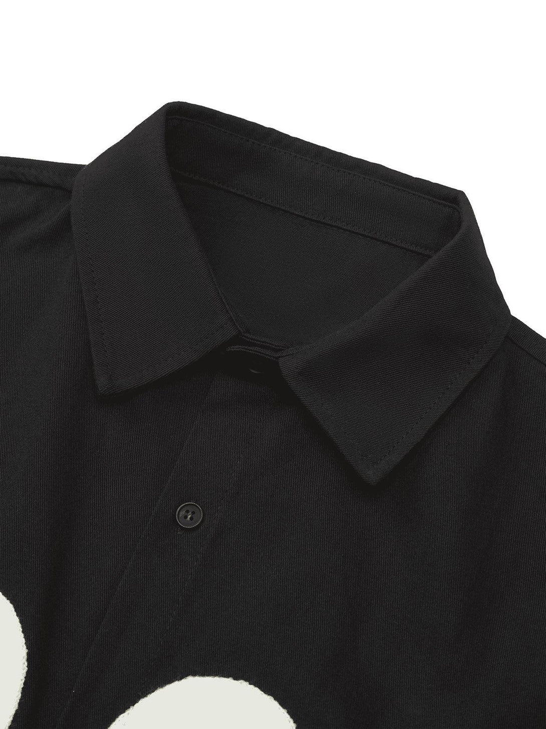 Detailed view of a black TALISHKO shirt collar, showcasing fine stitching and button details.
