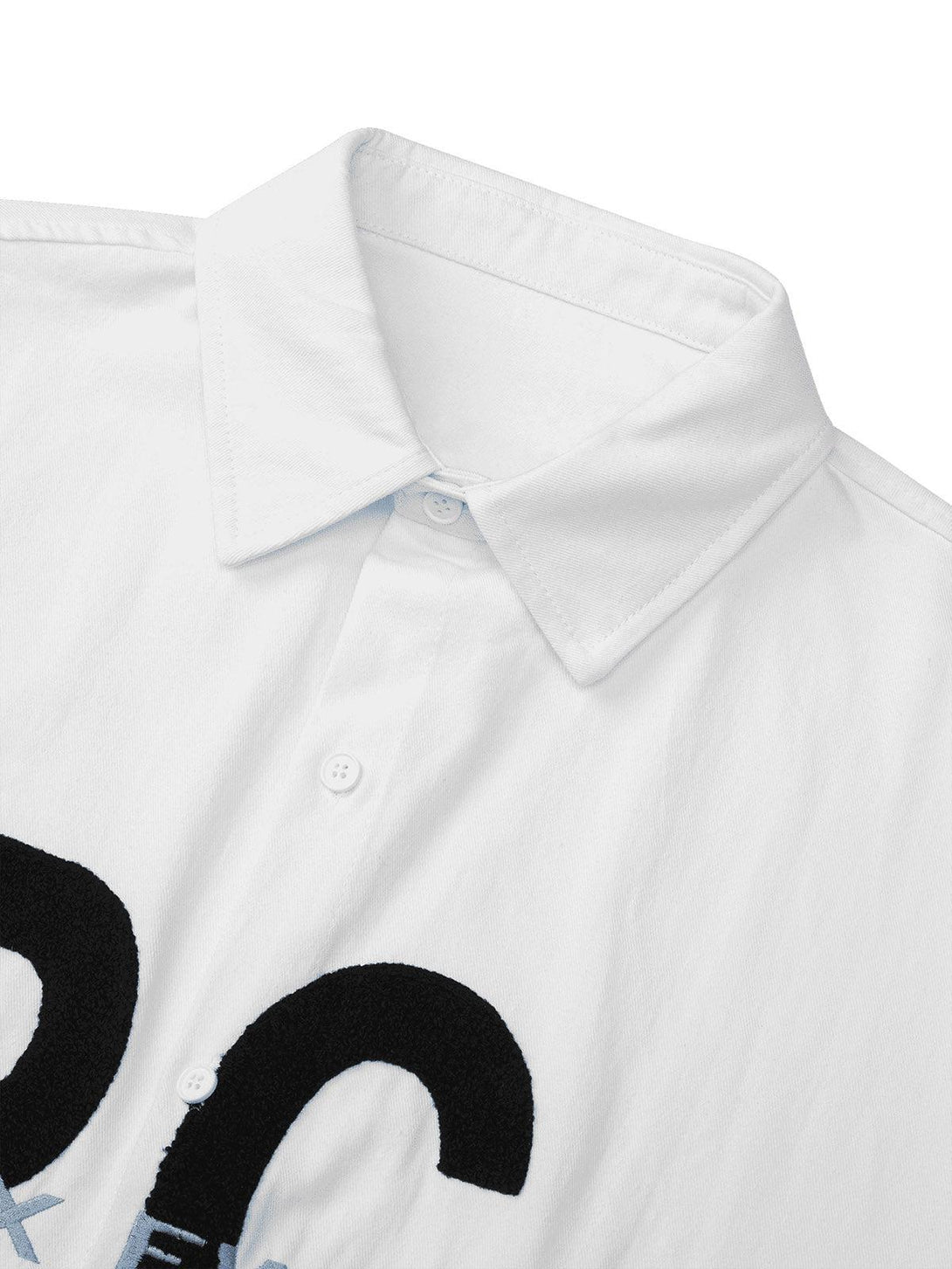 A close-up of TALISHKO's white shirt, featuring bold black and blue embroidered letters.