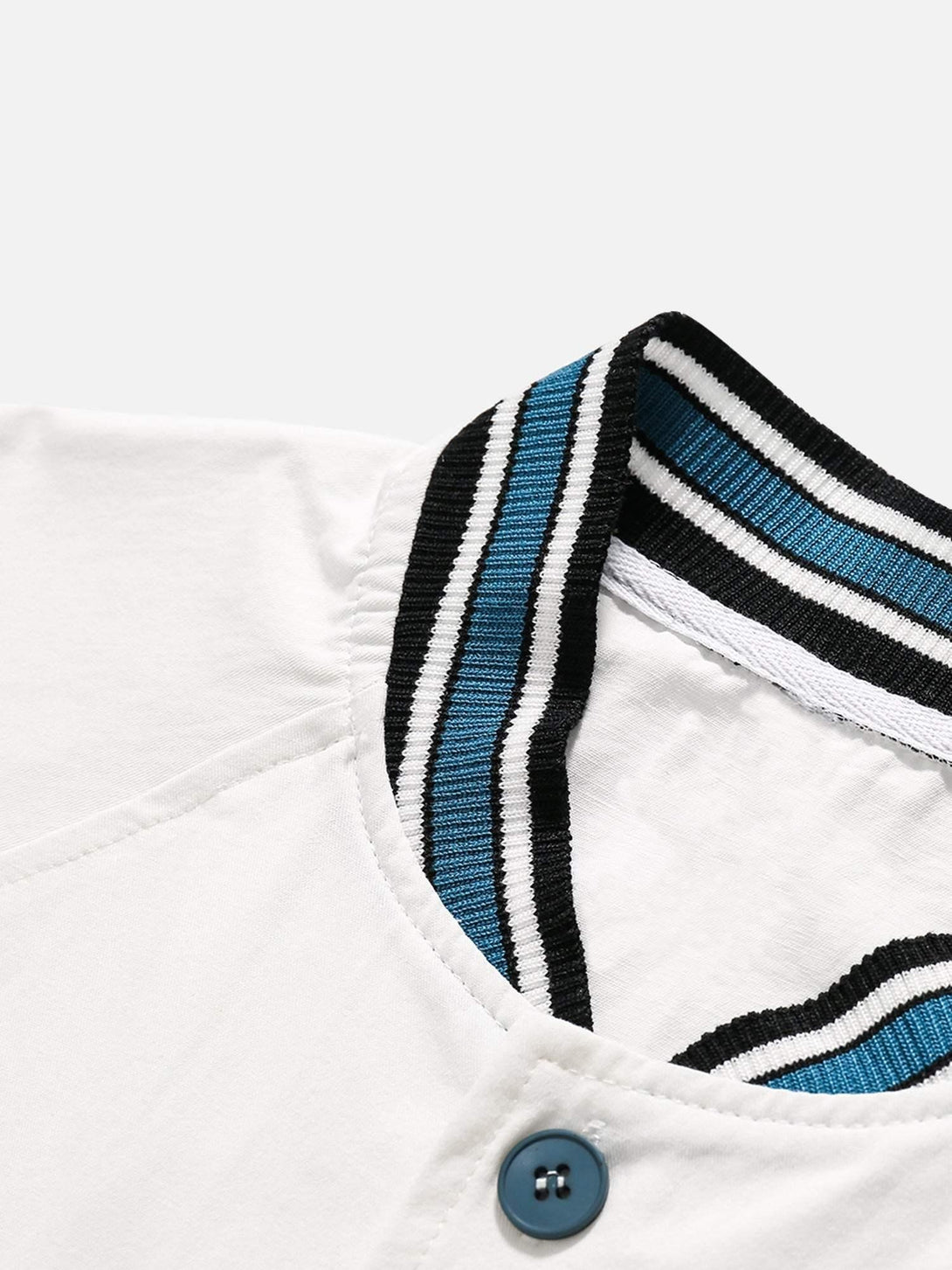 A detailed view of TALISHKO's striped collar and button detail on a retro-inspired shirt.