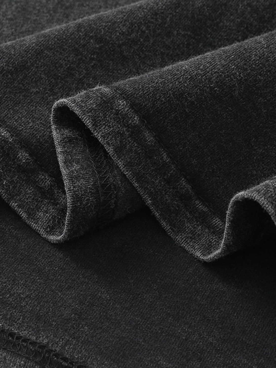 TALISHKO vest fabric detail highlighting soft texture and craftsmanship in a dark hue.