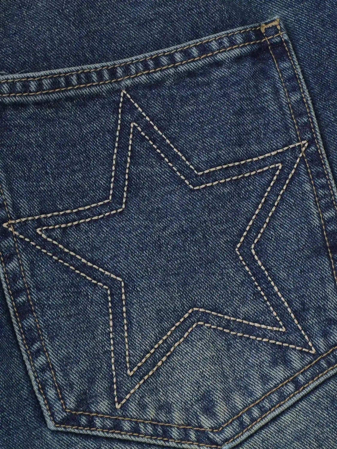 A close-up of TALISHKO denim shorts pocket, featuring star stitching for a retro vibe.