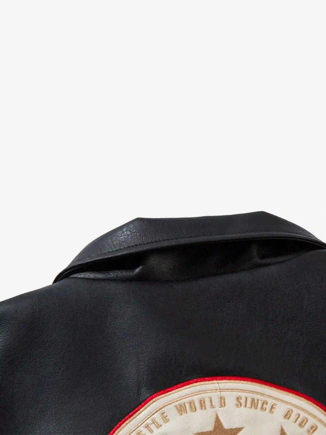 A detailed view of TALISHKO's retro patchwork motorcycle jacket collar and bold design.