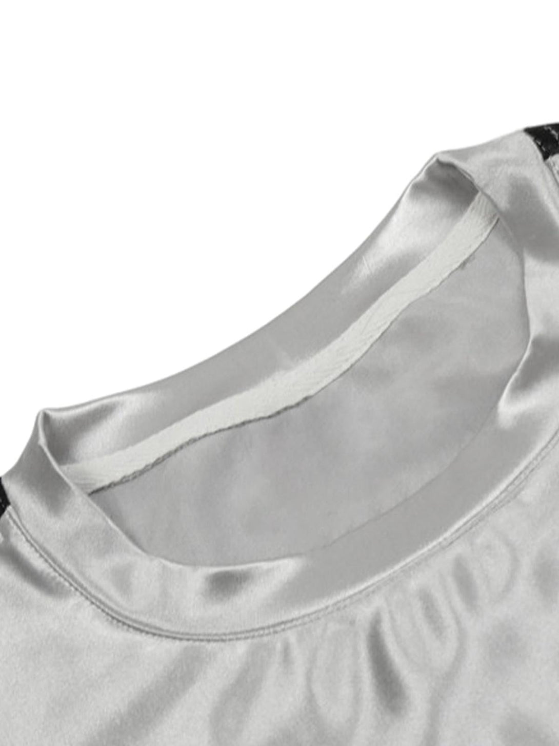A detailed view of the neckline on TALISHKO's silver patchwork long-sleeved T-shirt.