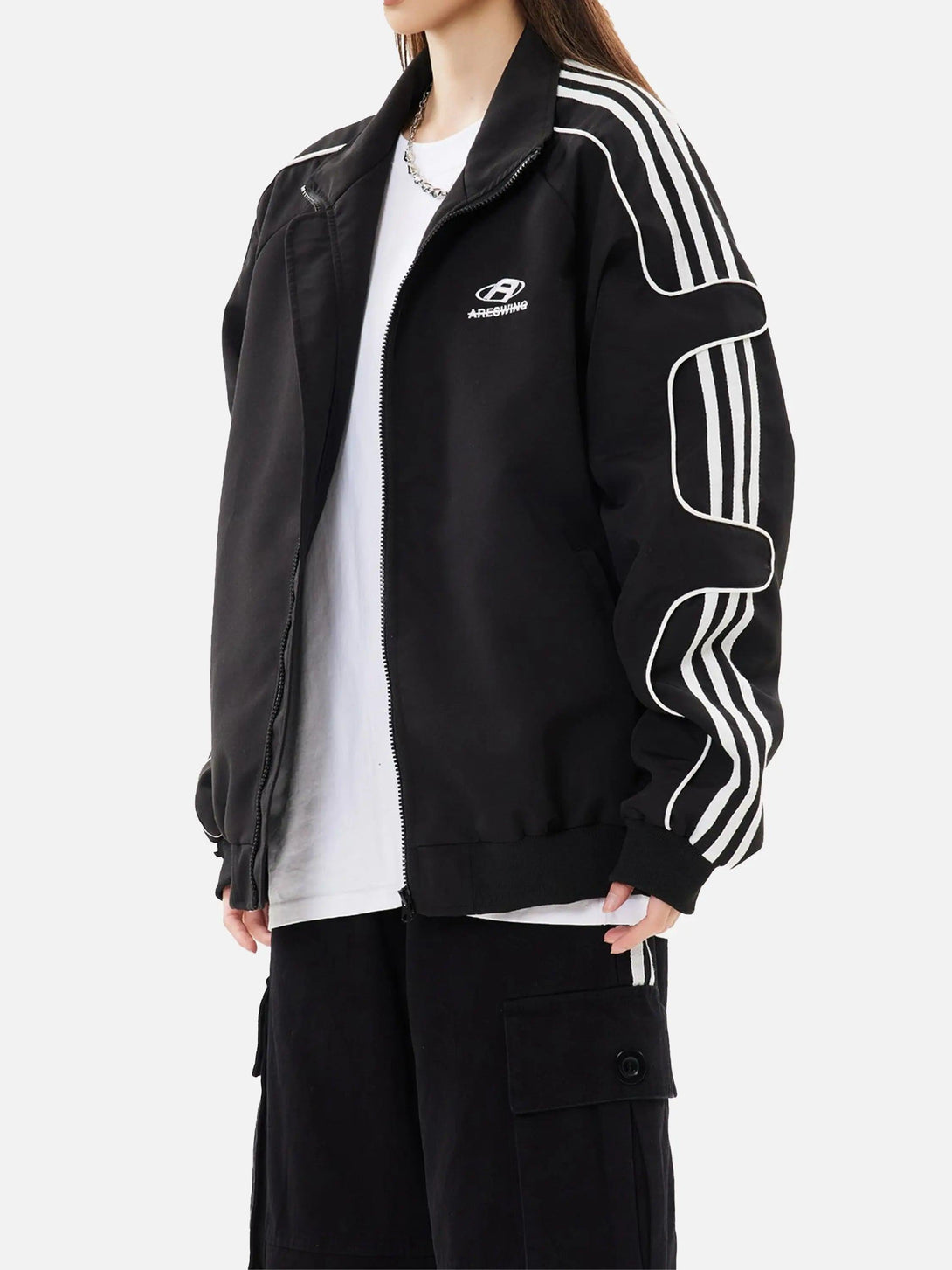 Model wearing a black TALISHKO sports jacket with white stripes, styled with a casual look.