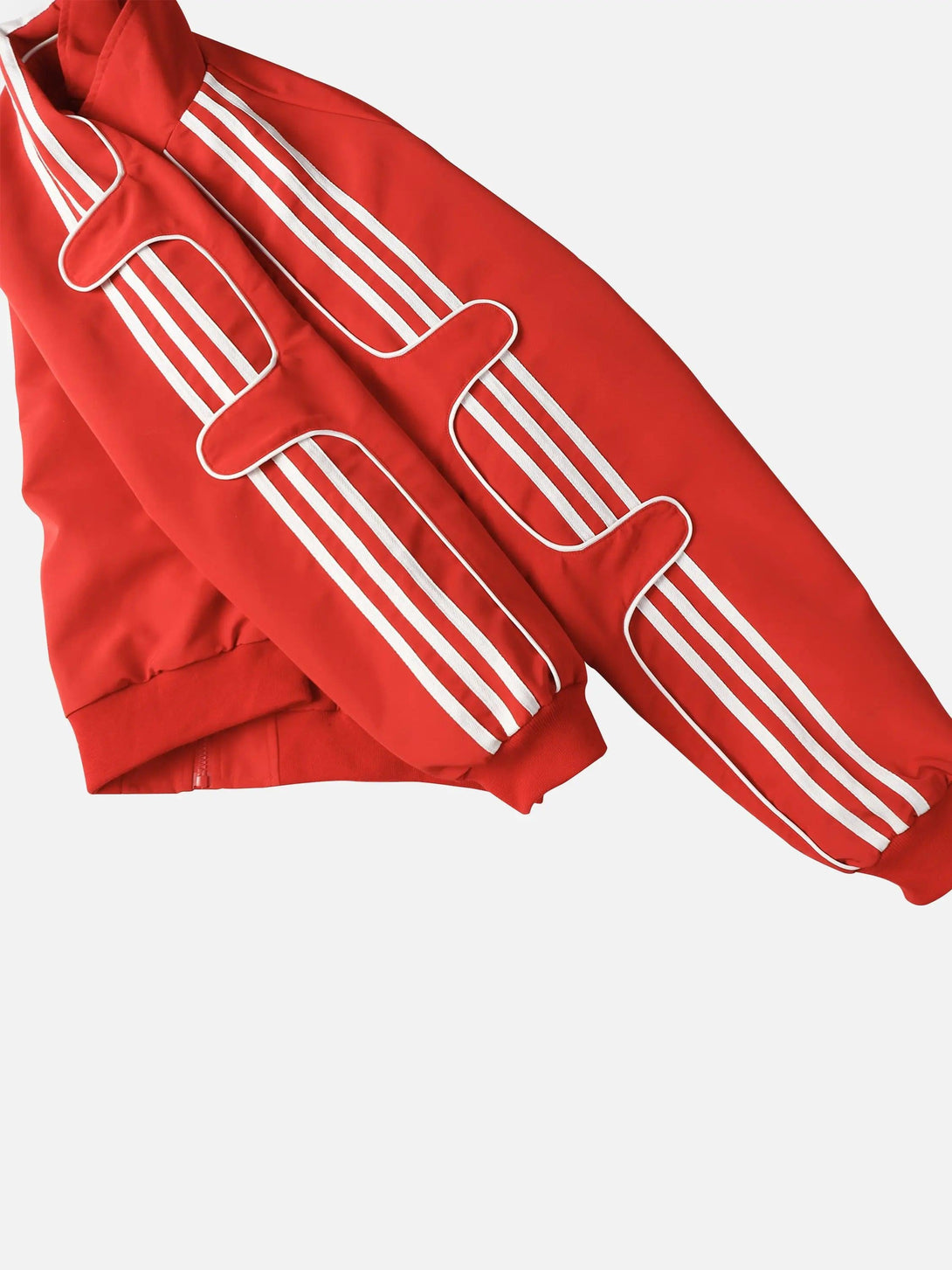 A detailed look at the red TALISHKO sports jacket with distinctive white stripe detailing.