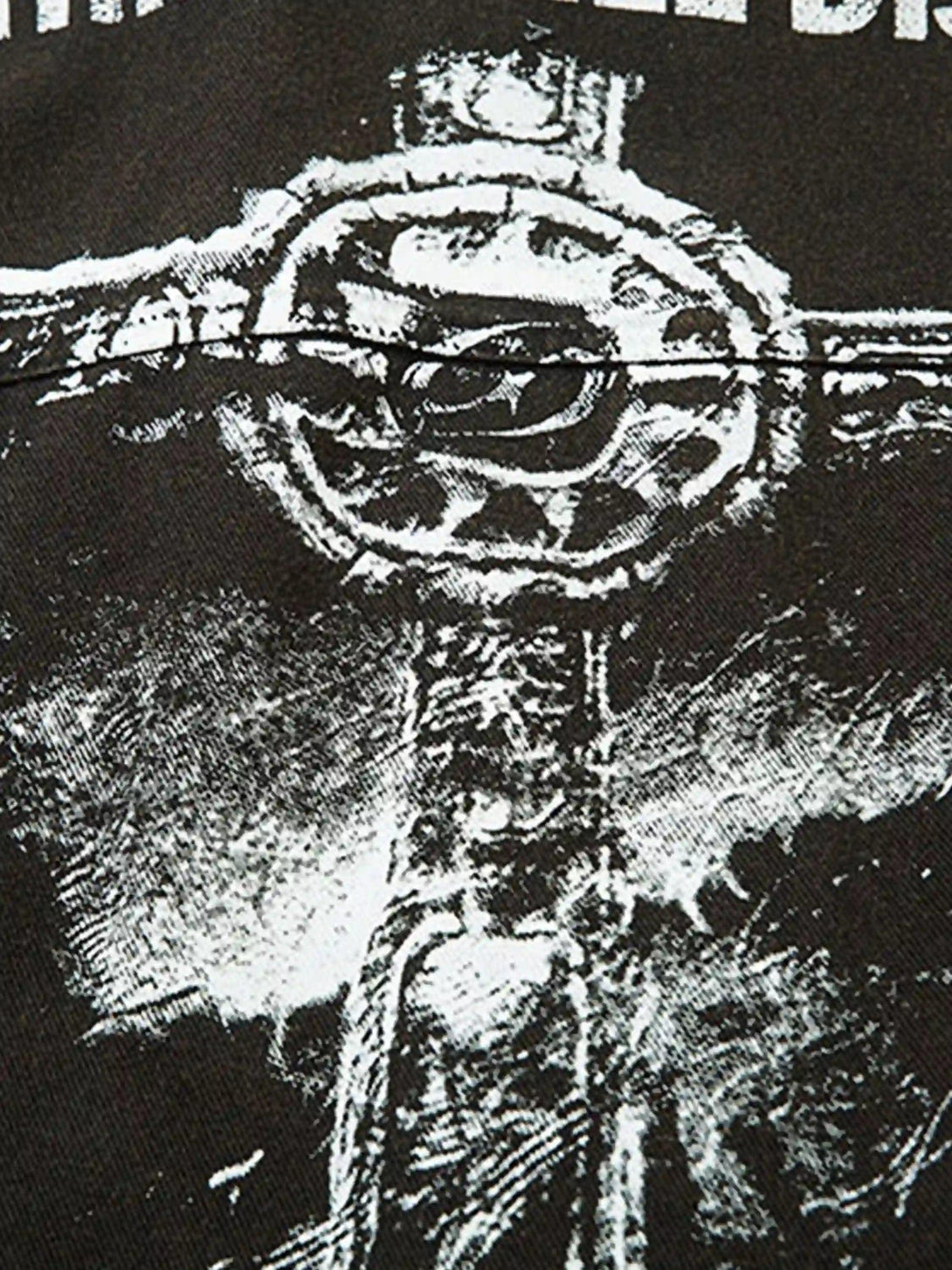 Intricate design detail from TALISHKO's shirt, showcasing a bold, textured graphic element.