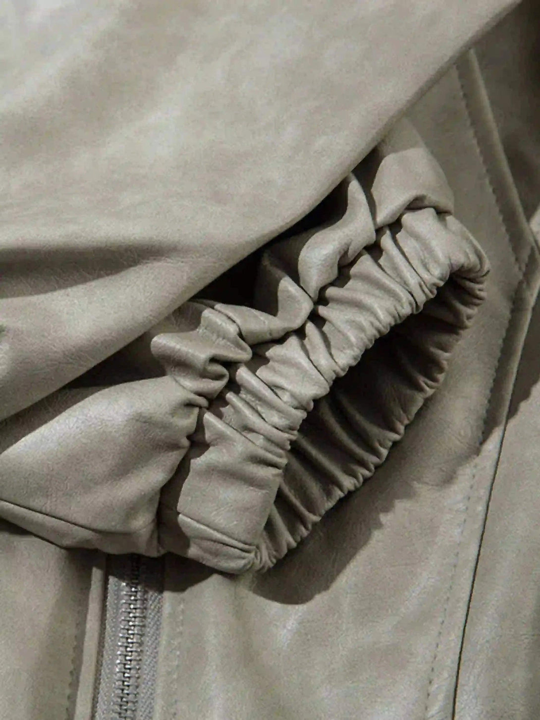 A close-up of TALISHKO's motorcycle jacket sleeve, highlighting its soft texture and elastic cuff.