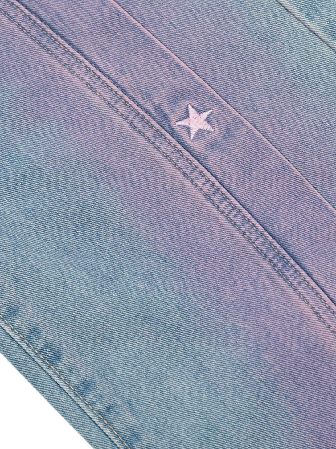 Intricate look at TALISHKO jeans' star embroidery and spray-painted texture, adding retro charm.