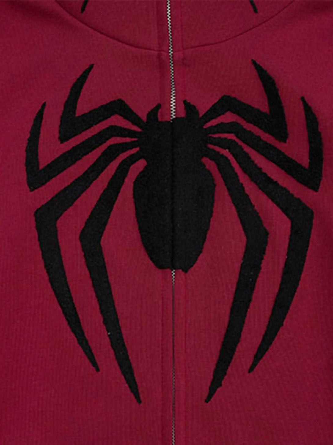 Detailed view of TALISHKO cardigan hoodie showcasing bold spider embroidery on red fabric.
