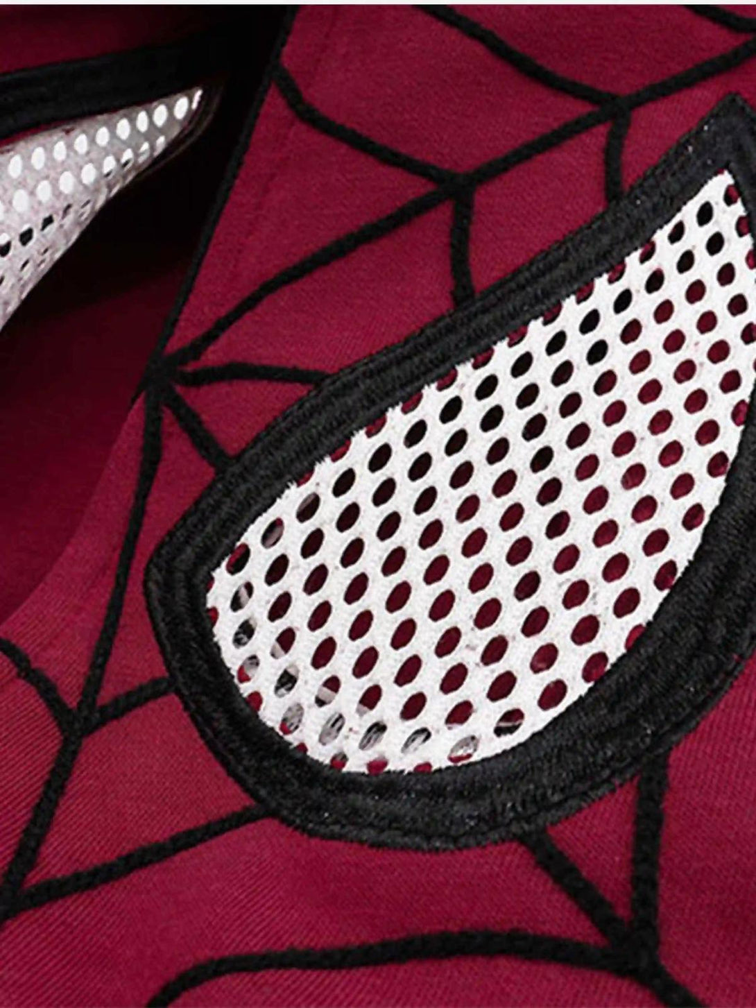 Intricate look at TALISHKO cardigan hoodie with spider web embroidery and mesh eye details.