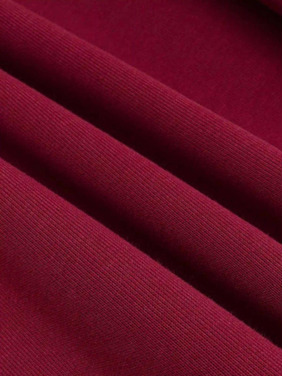 Zoomed-in texture of red TALISHKO cardigan hoodie fabric showcasing fine ribbed detail.