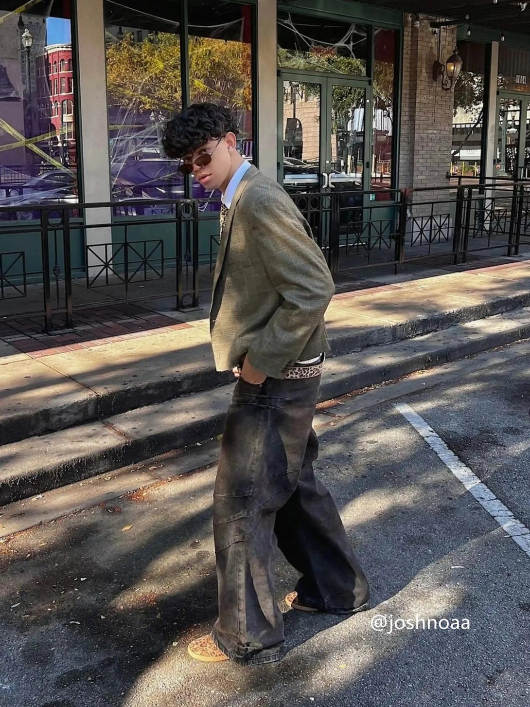 Model in oversized TALISHKO blazer and heavy industry washed jeans, embodying urban street fashion.