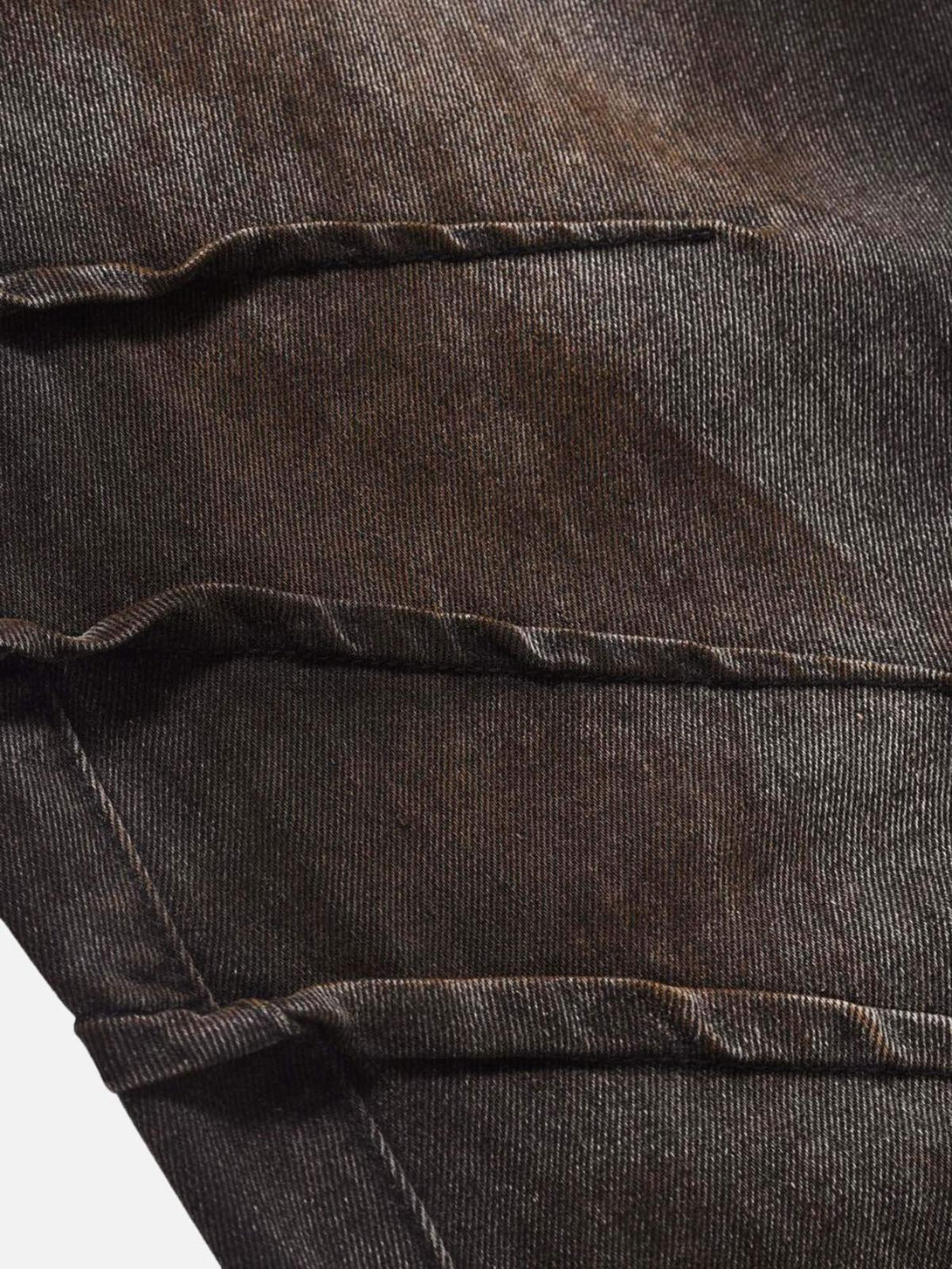 Zoomed-in texture of TALISHKO's heavy industry washed jeans, highlighting rugged details.