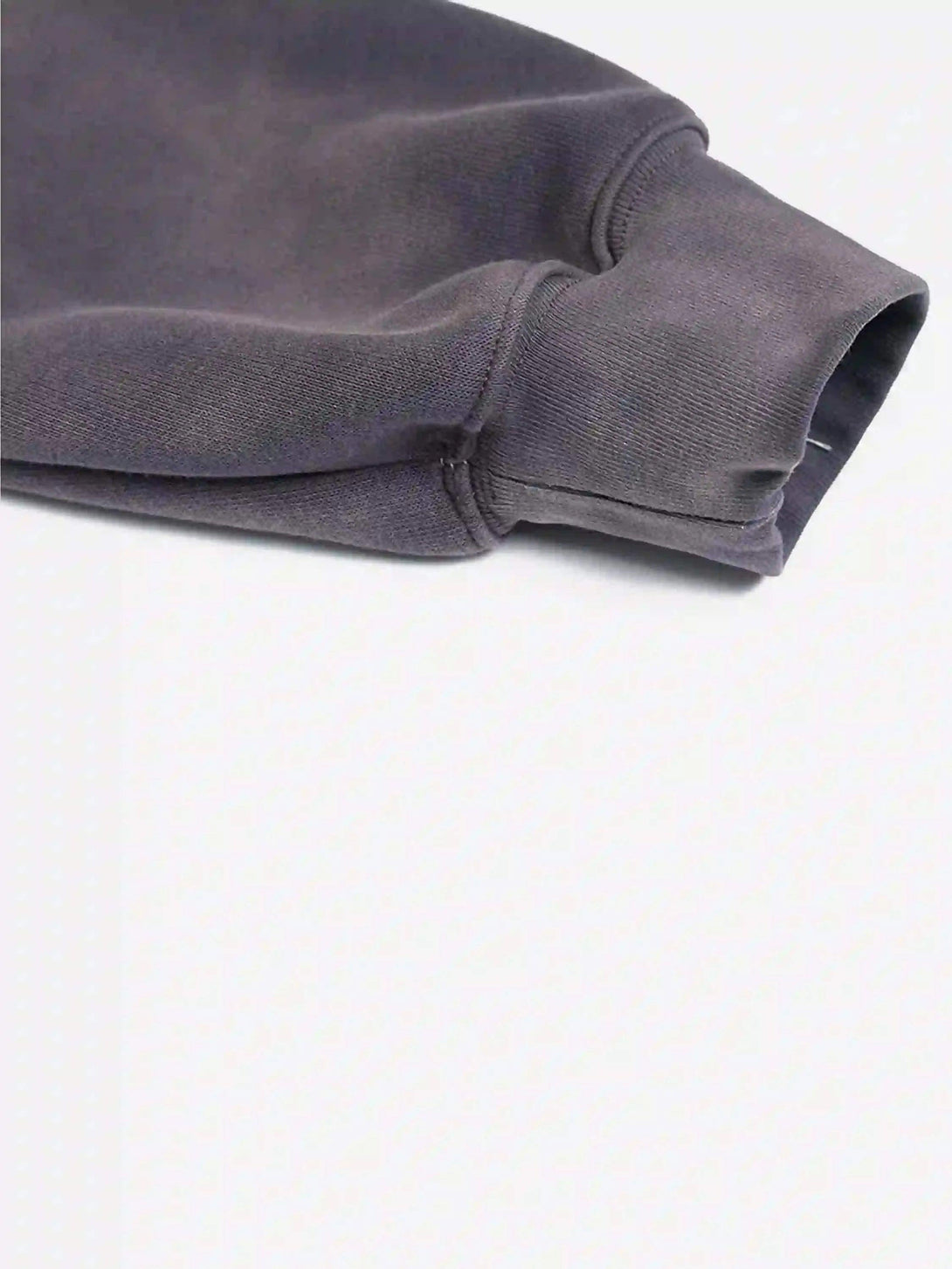 A close-up of TALISHKO hoodie sleeve highlighting the soft fabric and stitching details.