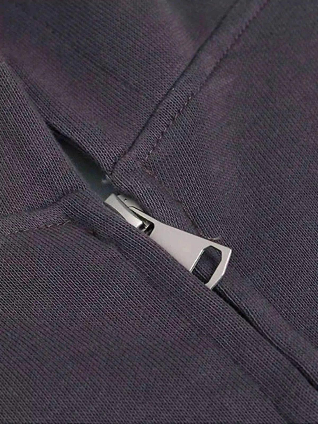 Detailed look at the TALISHKO hoodie zipper, showcasing quality stitching and sleek design.