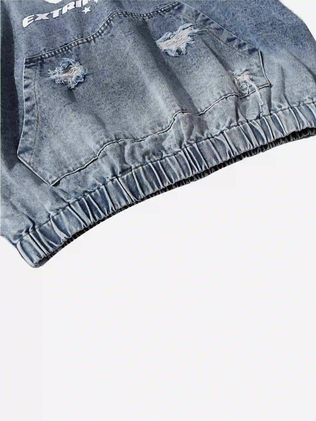 Intricate look at TALISHKO's distressed denim hoodie, highlighting the elastic hem and pocket details.