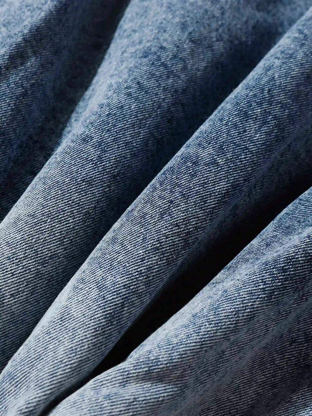 "Zoomed-in texture of TALISHKO's gradient denim hoodie, showcasing intricate fabric details."