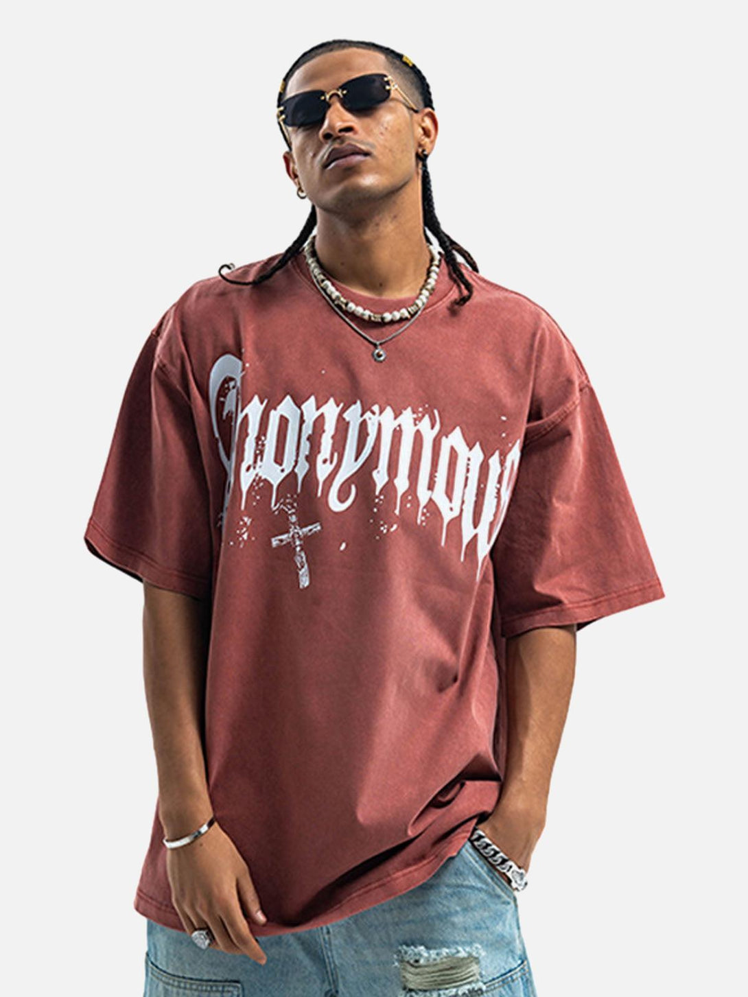 Model wearing a TALISHKO Gothic T-shirt in red with bold lettering and cross design, perfect for summer vibes.