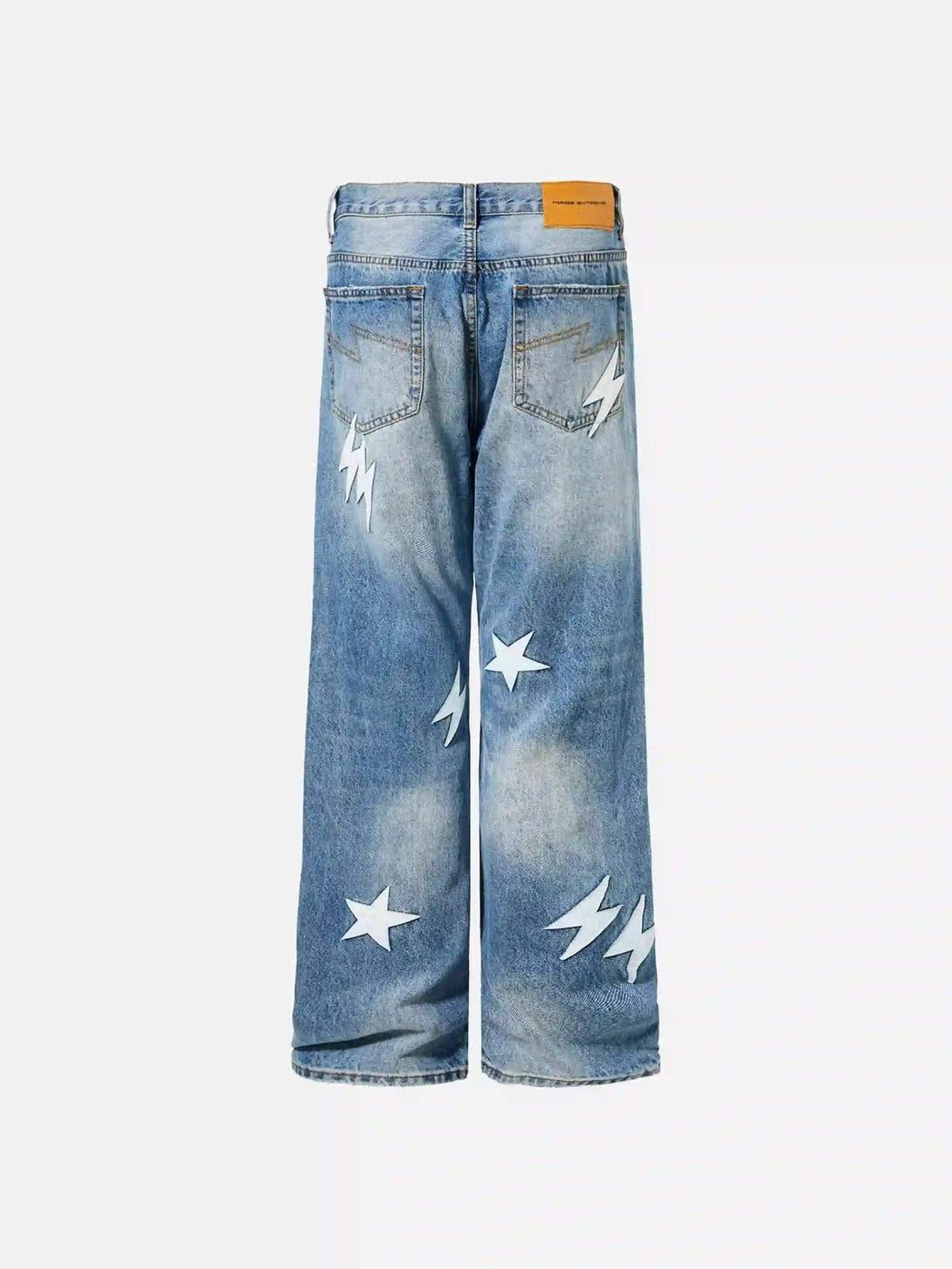 Back view of TALISHKO blue jeans with lightning and star patches, ideal for street style.