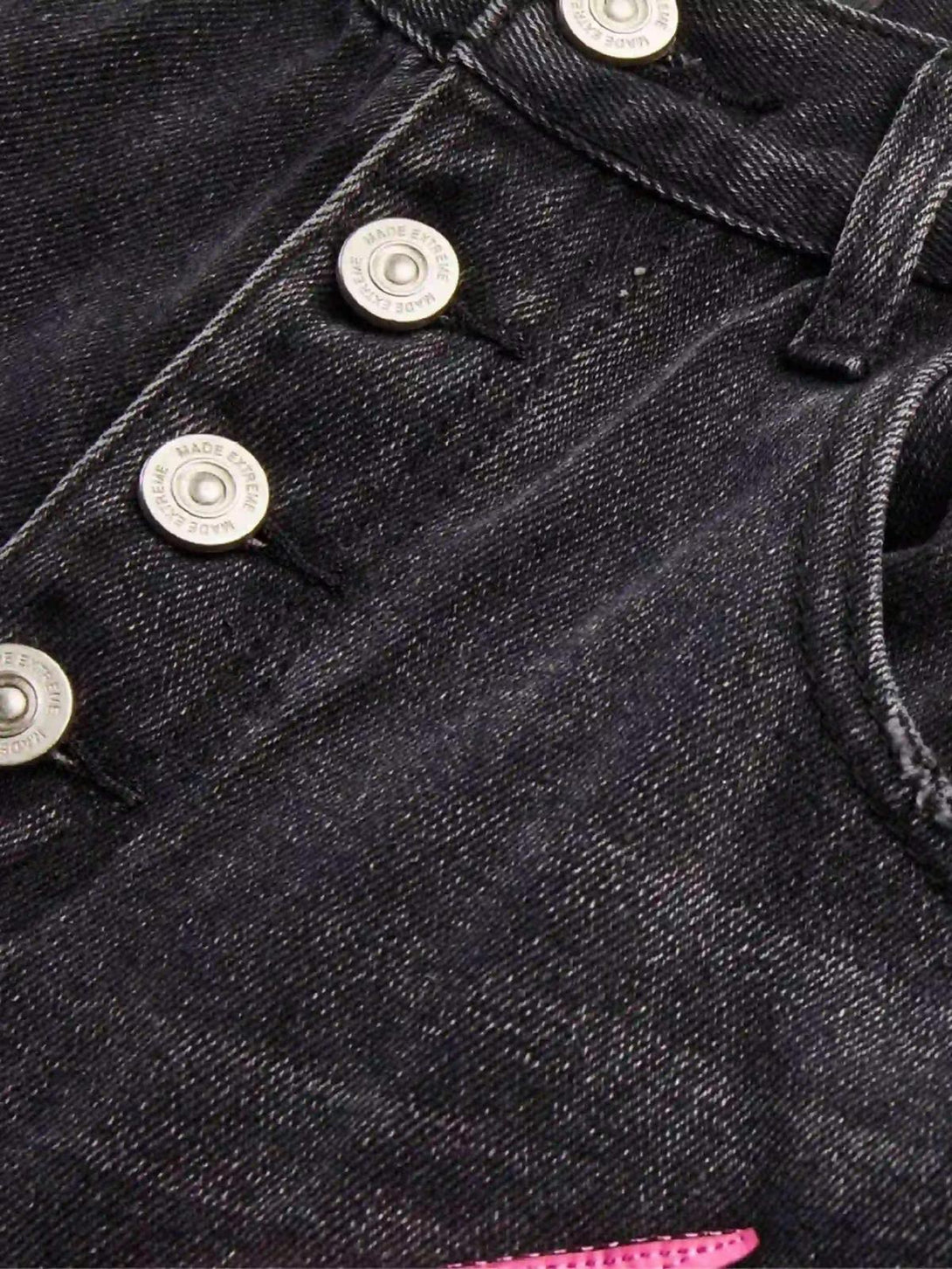 Detailed view of TALISHKO jeans, showcasing button detail and quality denim texture.