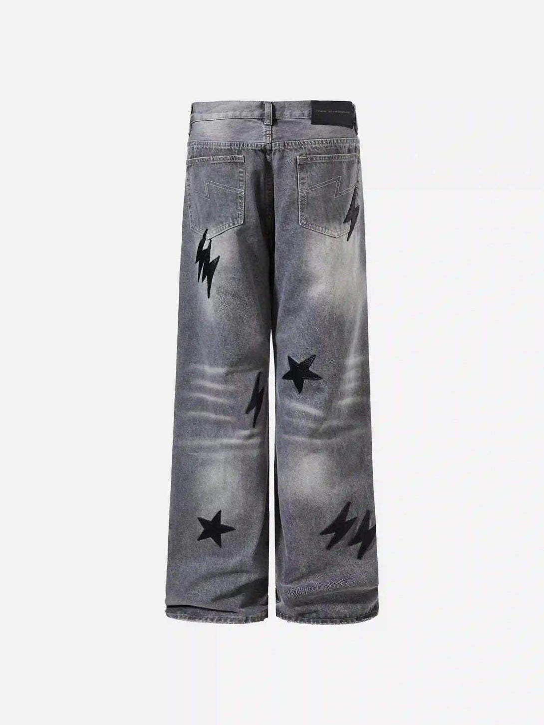 Back view of TALISHKO gray jeans featuring bold lightning and star designs for a unique look.