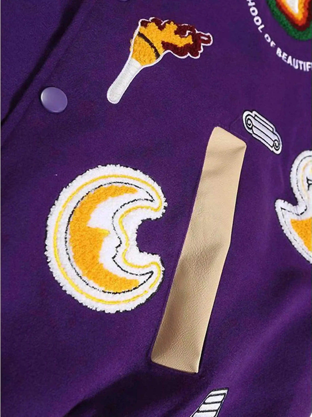 Zoomed-in texture of TALISHKO's purple retro jacket, highlighting colorful embroidered patches.