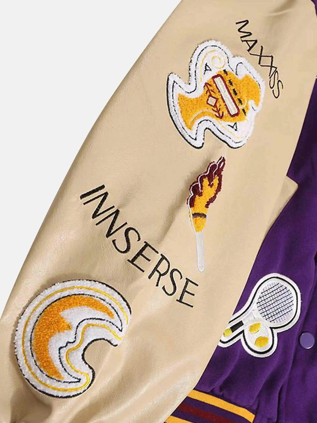 Intricate look at TALISHKO's embroidered patches on the retro baseball jacket sleeve.