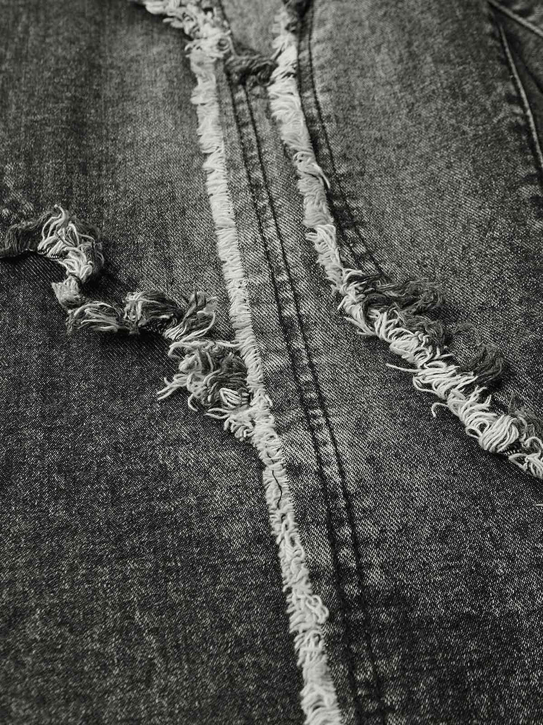 Zoomed-in texture of TALISHKO jeans, highlighting distressed seams for an edgy street style.