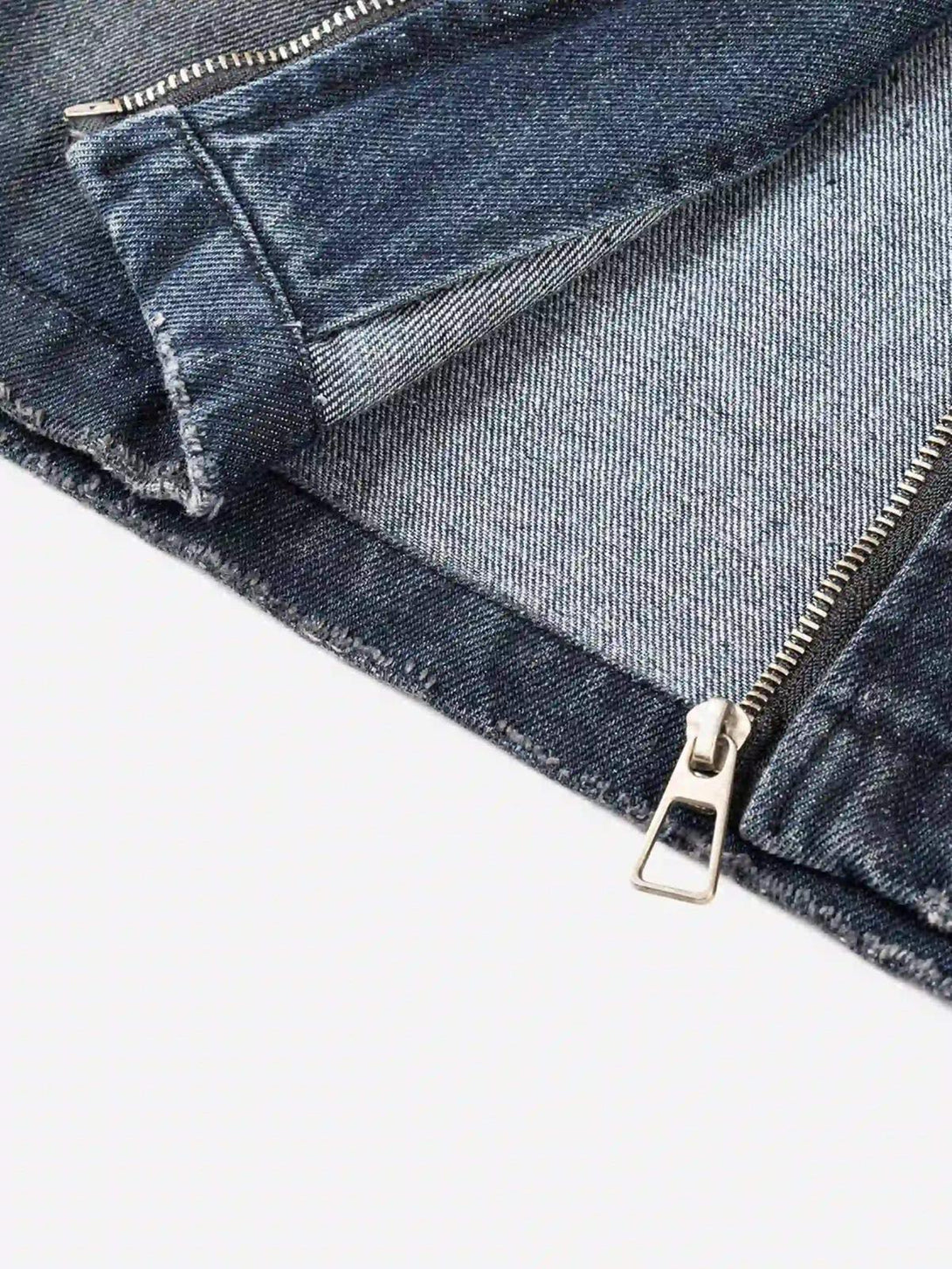 Focusing on the detailed zipper of a TALISHKO retro hoodie, highlighting denim texture.