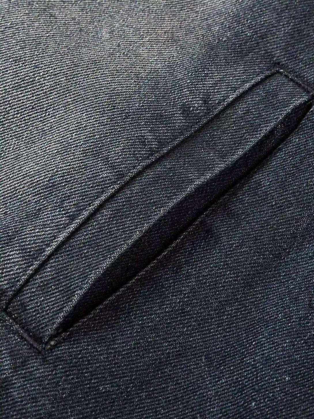 A detailed view of the pocket stitching on a TALISHKO retro hoodie, showcasing denim texture.