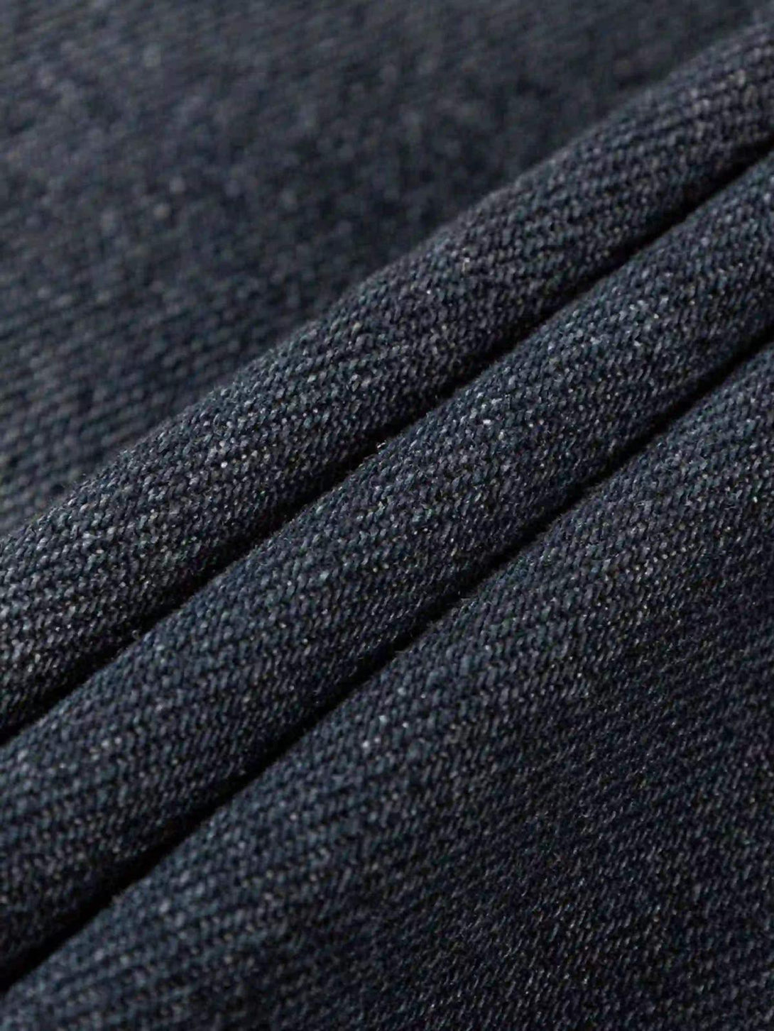 A tight crop highlighting the textured denim fabric on a TALISHKO retro street-style hoodie.