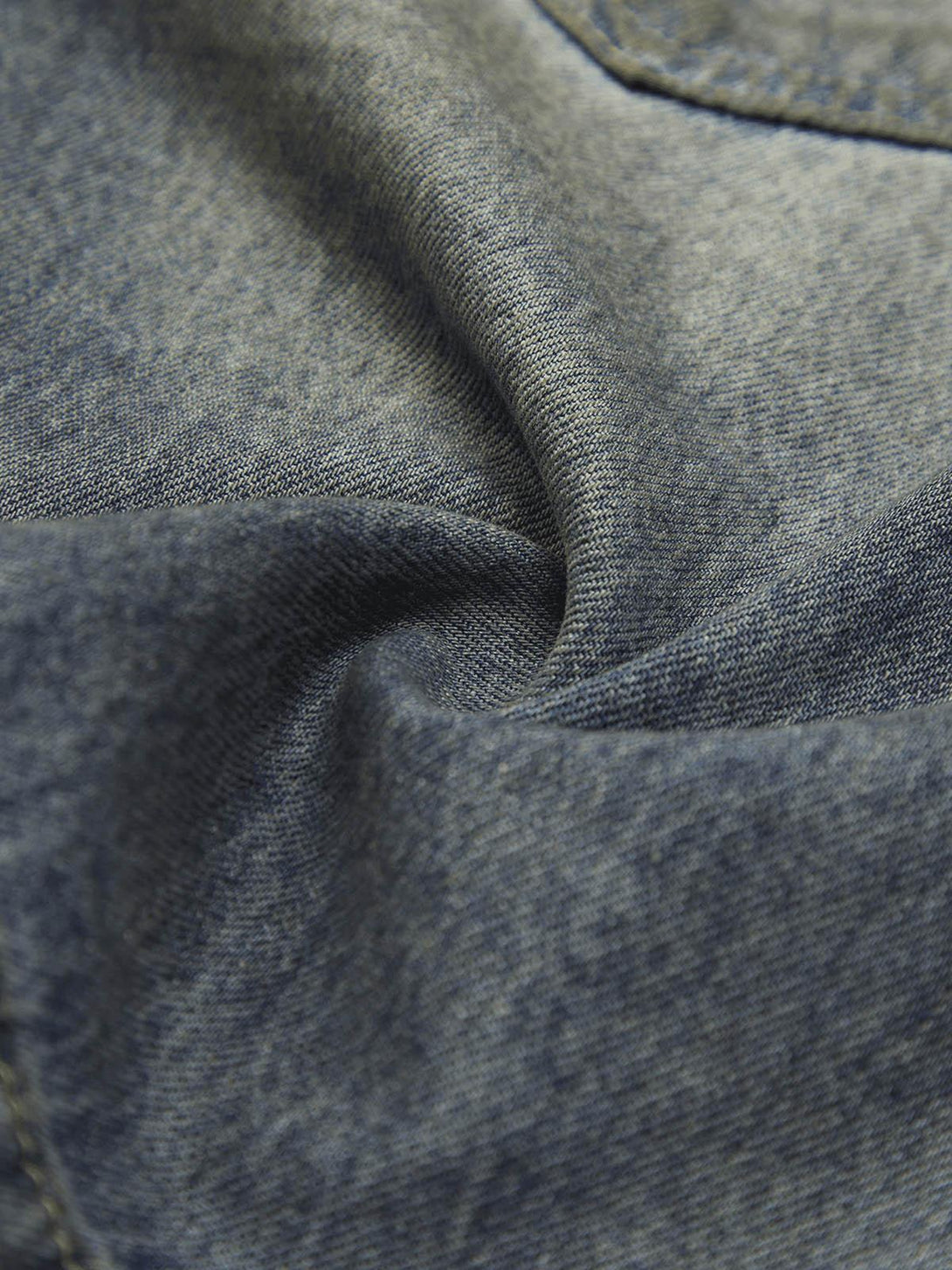 Zoomed-in texture of TALISHKO washed distressed shorts, highlighting the casual street vibe.