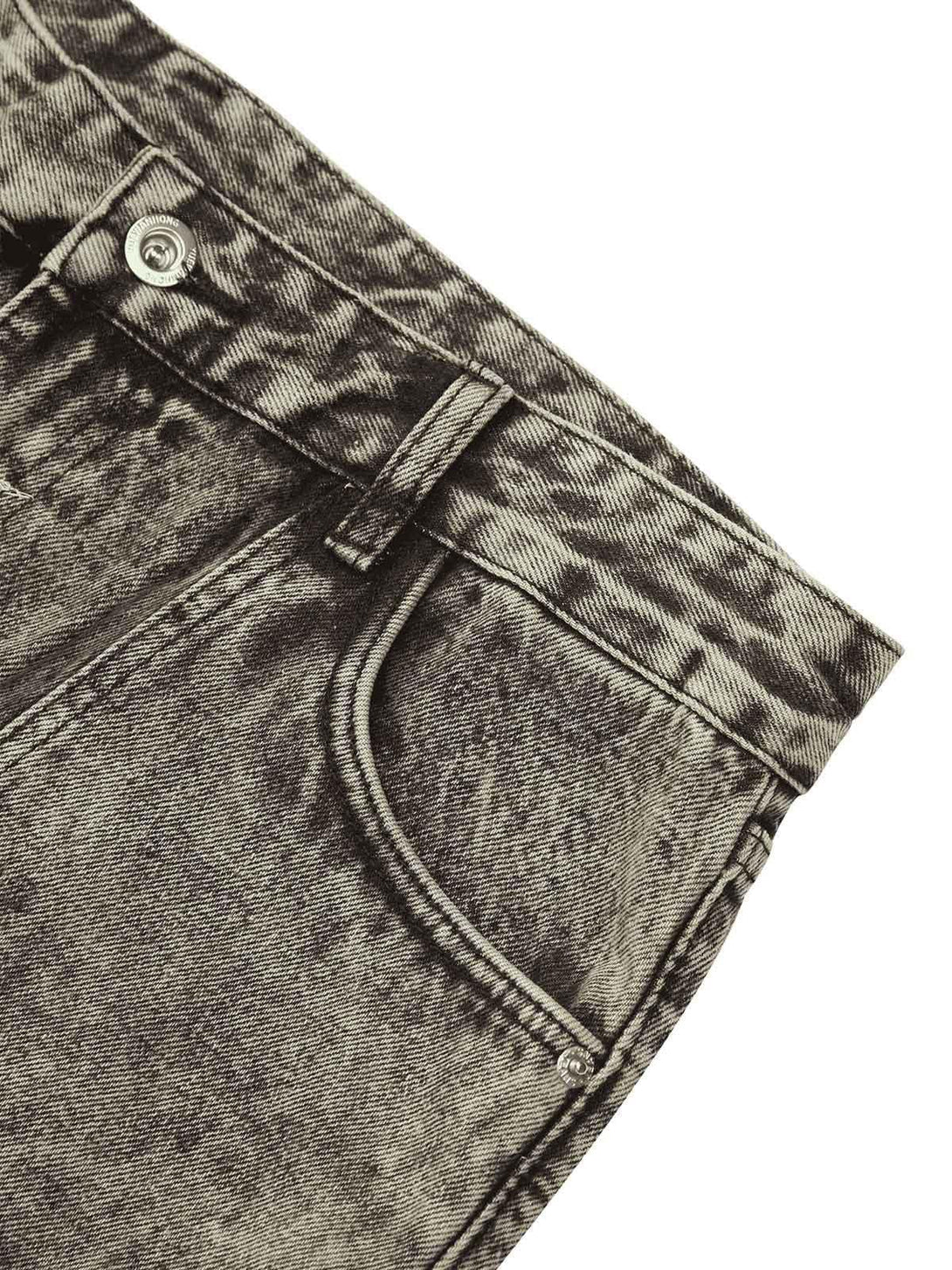 Detailed view of TALISHKO washed distressed jeans highlighting unique texture and stitching.
