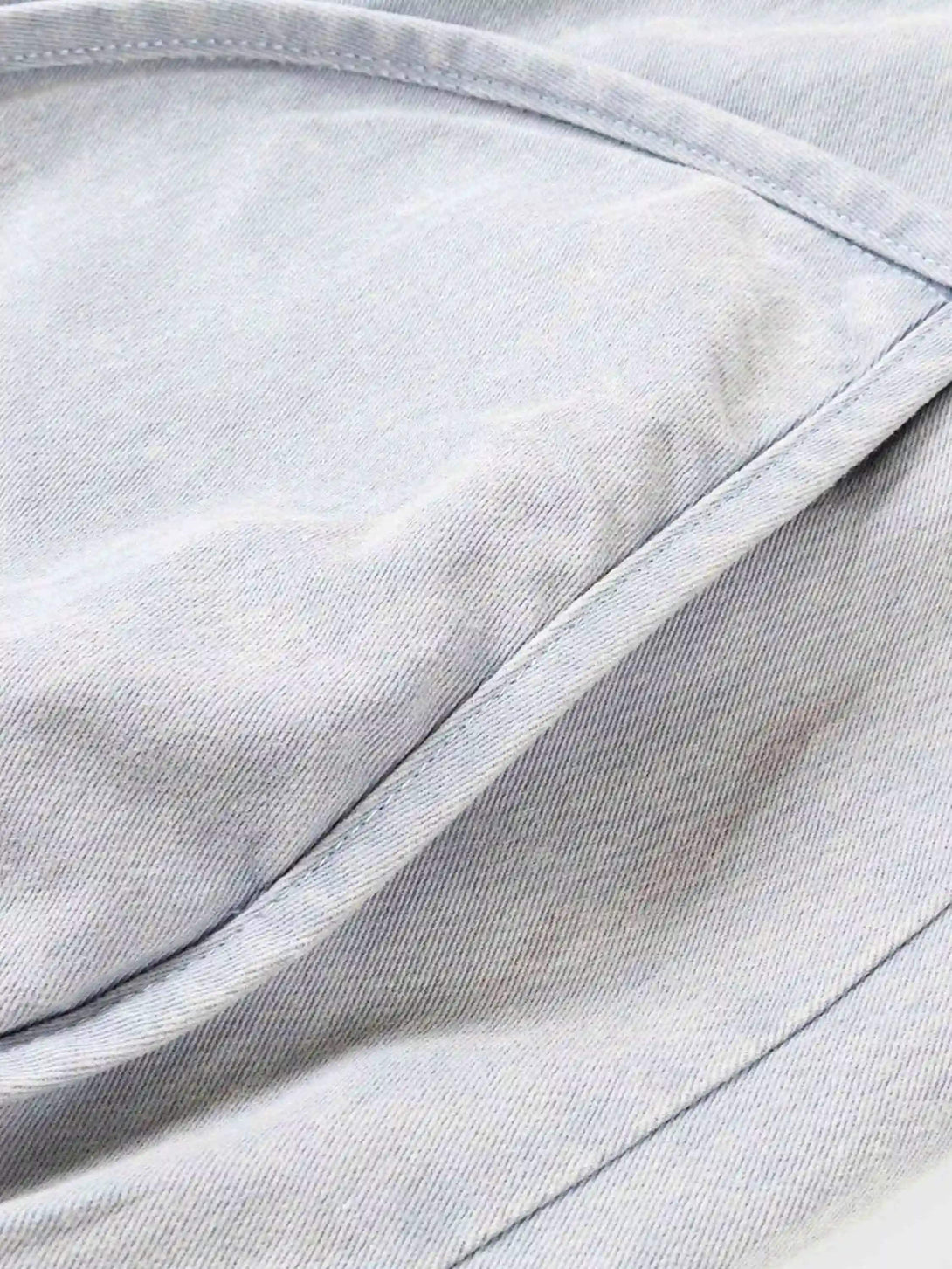 A detailed look at the washed fabric and stitching of the short jacket by TALISHKO.