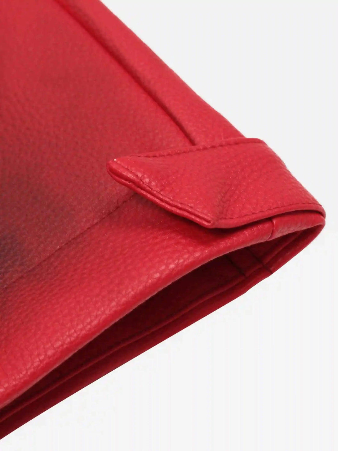 Focusing on the vibrant red leather detail of a TALISHKO motorcycle jacket.