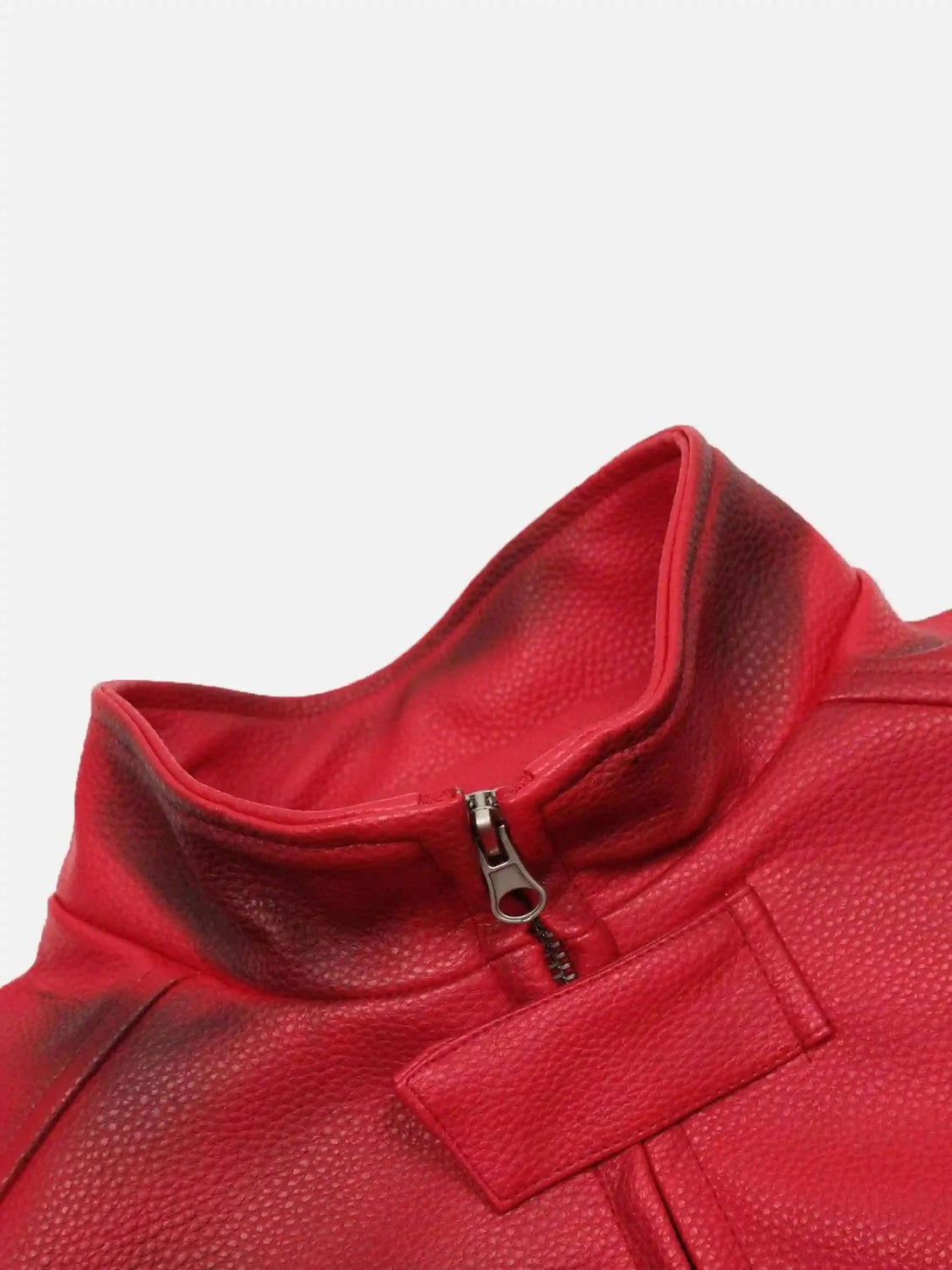 A close-up of TALISHKO's red motorcycle jacket, showcasing its textured leather and zipper detail.