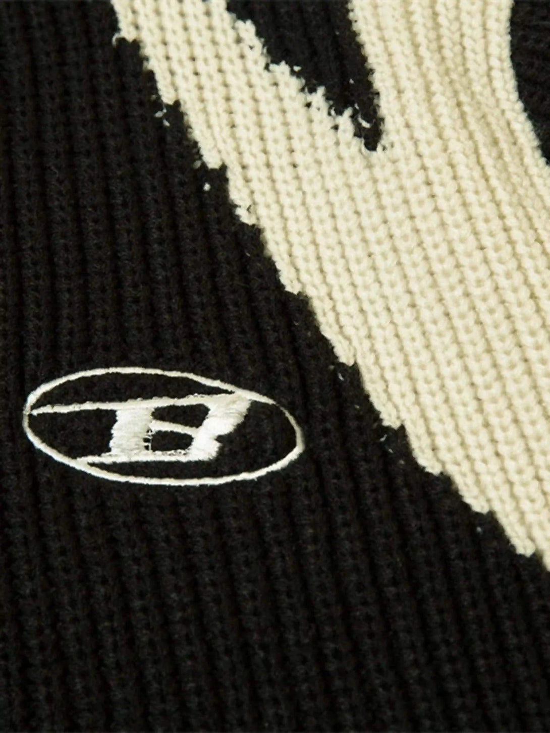 Intricate look at TALISHKO's cardigan, focusing on the ribbed knit and color-block design.
