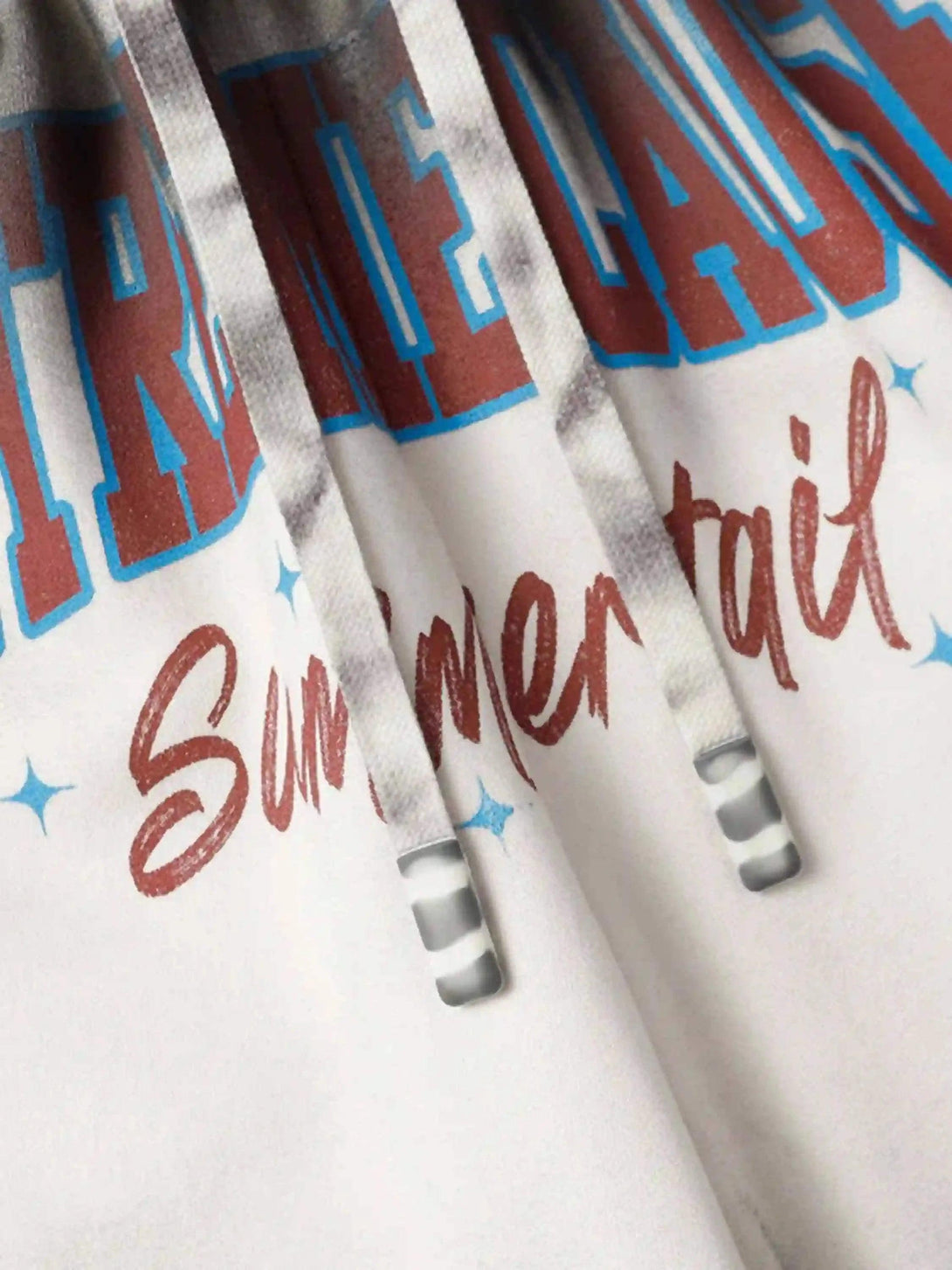 A tight crop highlighting "Summer" text detail on TALISHKO's gradient print shorts.