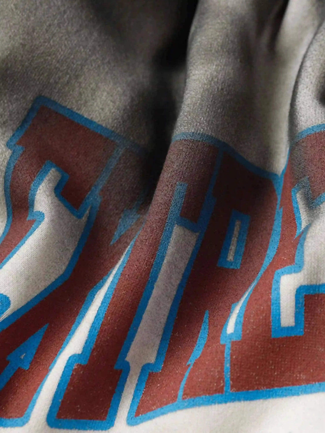 Intricate look at TALISHKO's gradient print fabric, showcasing bold typography for a trendy vibe.