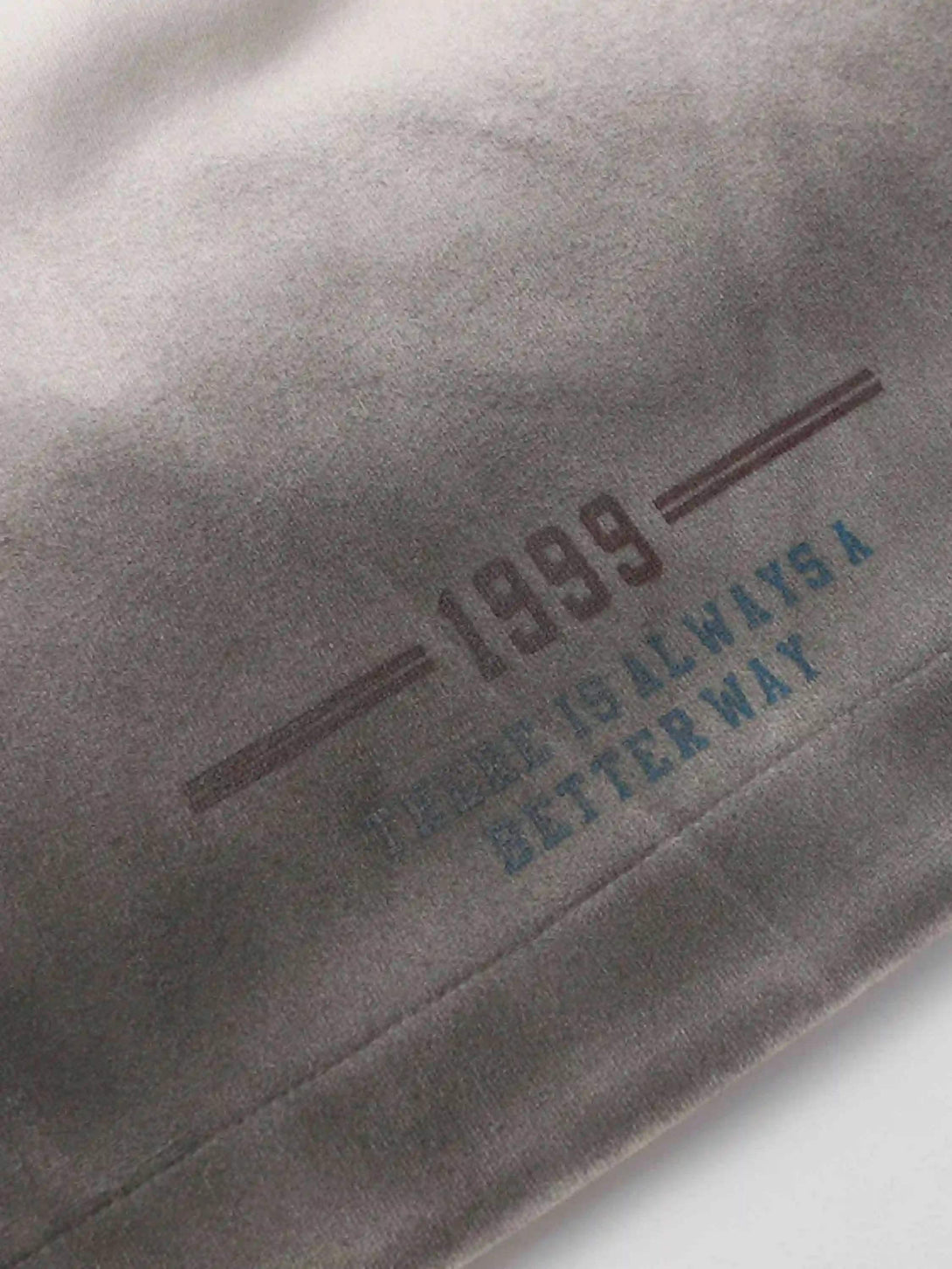 Zoomed-in view of TALISHKO's gradient print shorts, featuring bold typography detail.