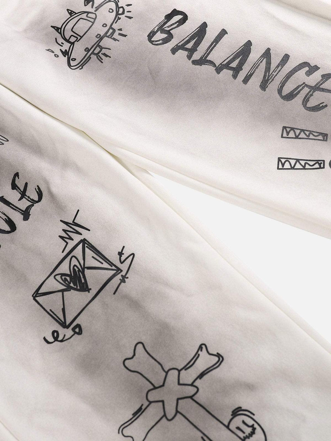 Intricate designs on TALISHKO sweatpants highlighting spray-painted graphics and casual style.