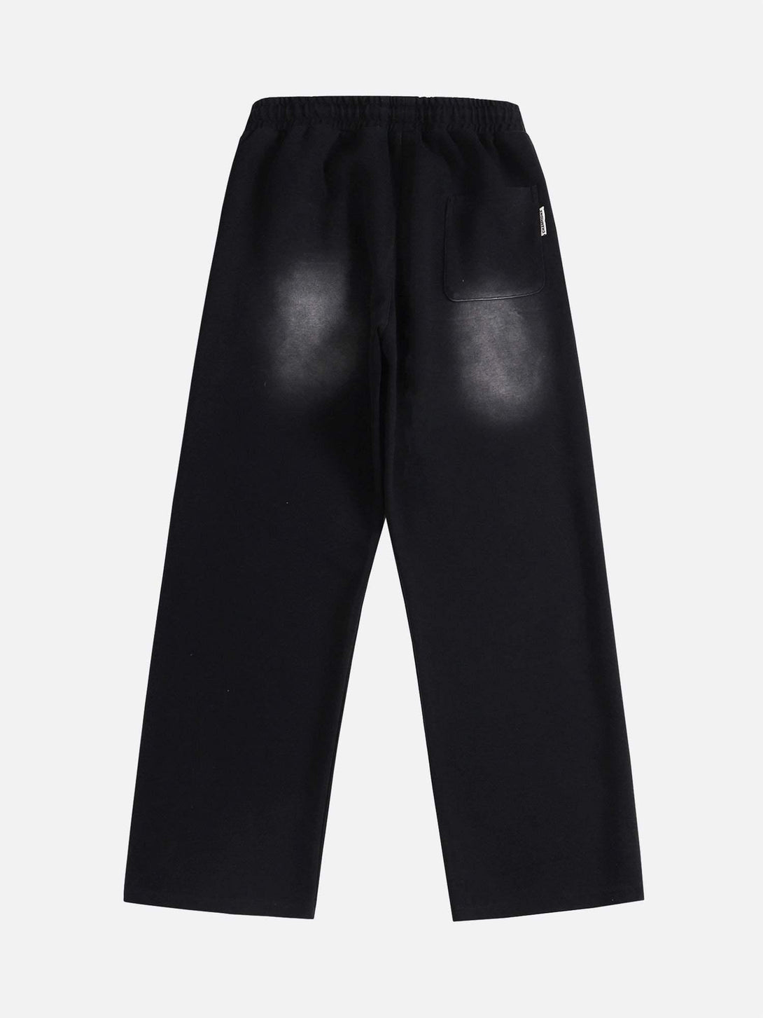 Back view of TALISHKO sweatpants in black, showcasing spray-painted effect and relaxed fit.