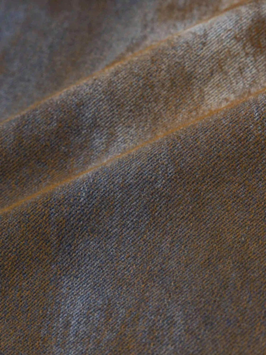 Zoomed-in texture of TALISHKO's denim jorts, highlighting their rugged, worn appeal.